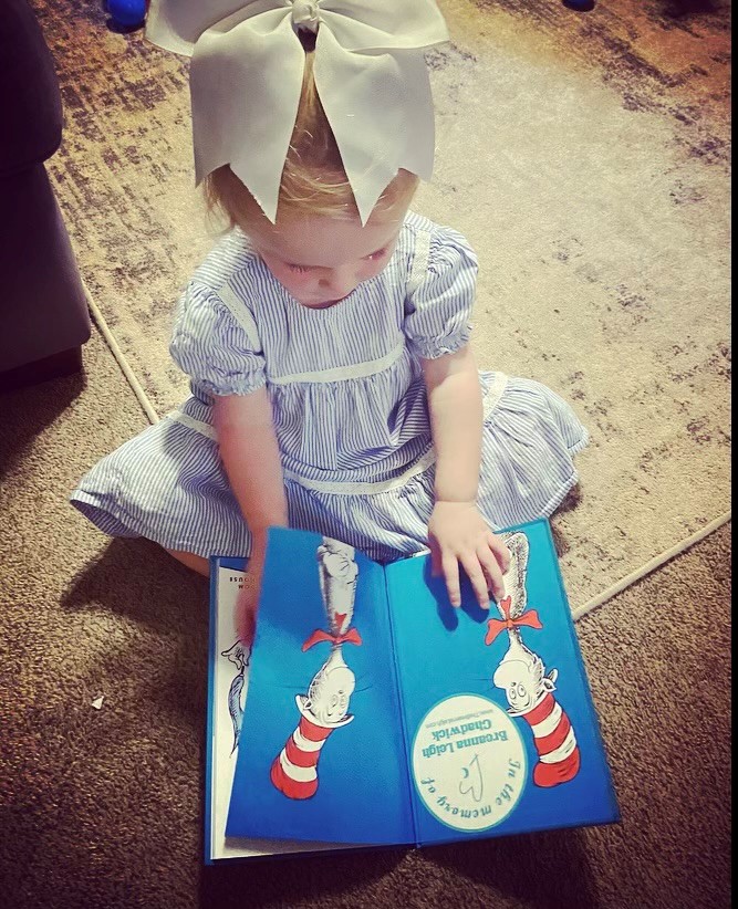 A young reader enjoying a Dr. Seuss book