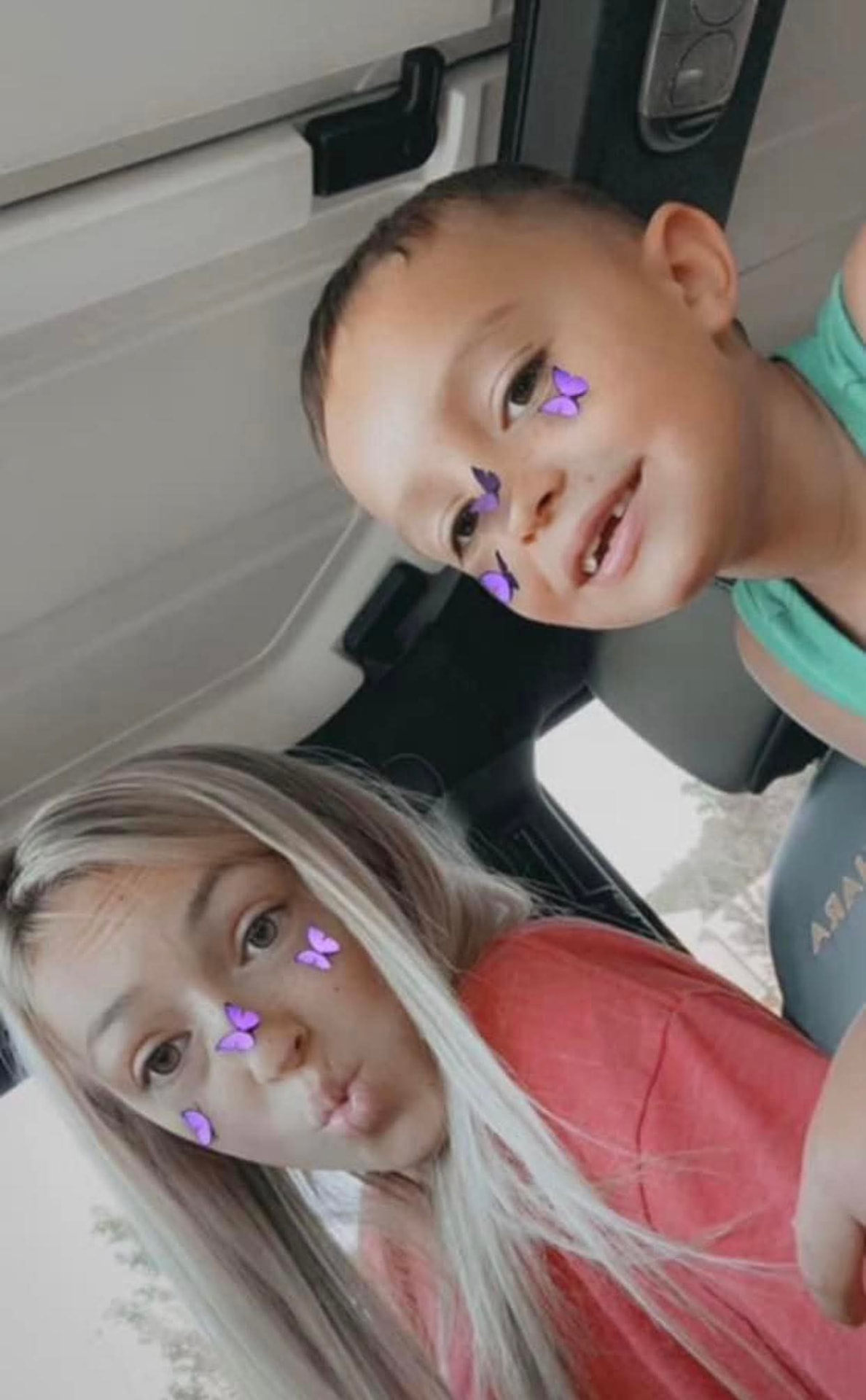 Bree with a little boy, sharing a silly selfie