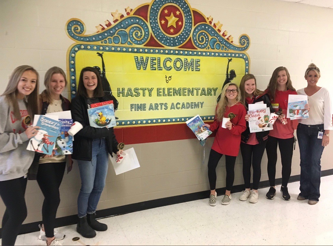 Bree and friends sharing books with students at Hasty Elementary